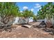 Expansive backyard features mature trees, decorative rock and a charming wooden bridge at 5320 W Soft Wind Dr, Glendale, AZ 85310
