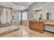 A luxurious bathroom featuring a walk-in shower with mosaic tile and a granite countertop vanity at 5320 W Soft Wind Dr, Glendale, AZ 85310