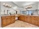A spacious bathroom features dual sinks, granite countertops and a large mirror for a luxurious feel at 5320 W Soft Wind Dr, Glendale, AZ 85310
