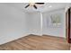 A bright and airy bedroom offers natural light and new wood look flooring at 5320 W Soft Wind Dr, Glendale, AZ 85310