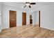 Spacious bedroom with wood-look floors, white walls and wood doors at 5320 W Soft Wind Dr, Glendale, AZ 85310