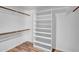 This walk-in closet features built-in shelves and wood floors at 5320 W Soft Wind Dr, Glendale, AZ 85310