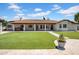 A lush backyard with a home featuring a timeless design, stucco exterior, and a red tile roof exudes elegance at 5320 W Soft Wind Dr, Glendale, AZ 85310