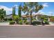 Beautiful front exterior featuring lush landscaping, desert plants, and a circular driveway at 5320 W Soft Wind Dr, Glendale, AZ 85310