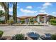 Stunning home featuring a beautifully landscaped front yard with circular driveway and desert landscaping at 5320 W Soft Wind Dr, Glendale, AZ 85310