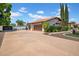 Spacious three car garage with attractive doors and mature landscaping at 5320 W Soft Wind Dr, Glendale, AZ 85310