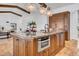 Spacious kitchen island boasts a granite countertop, ample storage, built-in microwave, and pendant lighting at 5320 W Soft Wind Dr, Glendale, AZ 85310
