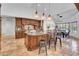 Entertainer's kitchen featuring a large island, custom cabinetry, pendant lighting, and stainless appliances at 5320 W Soft Wind Dr, Glendale, AZ 85310