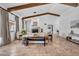Cozy living room featuring a fireplace, tile flooring, contemporary furnishings, and large windows at 5320 W Soft Wind Dr, Glendale, AZ 85310