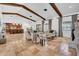 Spacious living room featuring high ceilings, exposed wood beams, tile flooring, and abundant natural light at 5320 W Soft Wind Dr, Glendale, AZ 85310