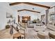 Bright living room boasting exposed wood beams, tile flooring, and comfortable seating arrangements at 5320 W Soft Wind Dr, Glendale, AZ 85310