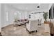 Bright and airy living room featuring a large window, tile floors, and comfortable seating at 5320 W Soft Wind Dr, Glendale, AZ 85310