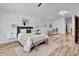 This stylish main bedroom features wood floors, recessed lighting, and a sitting area at 5320 W Soft Wind Dr, Glendale, AZ 85310