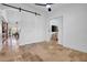 Neutral room featuring tiled flooring, barn door access, and a ceiling fan at 5320 W Soft Wind Dr, Glendale, AZ 85310
