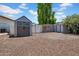 Practical backyard storage solution with a well-maintained shed featuring a clean design and ample space for tools and equipment at 5320 W Soft Wind Dr, Glendale, AZ 85310