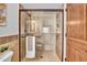 Modern shower with glass door, tiled walls, rainfall shower head, and built-in niche at 5320 W Soft Wind Dr, Glendale, AZ 85310