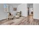 Charming sitting area boasts neutral furniture, wood floors, and a bright airy feel at 5320 W Soft Wind Dr, Glendale, AZ 85310
