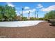 Backyard featuring a private volleyball court offering recreational space and mature landscaping for outdoor enjoyment at 5320 W Soft Wind Dr, Glendale, AZ 85310