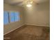 Carpeted bedroom with two windows and a ceiling fan, perfect for relaxation at 5933 E Main St # 1, Mesa, AZ 85206