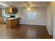 Bright dining area adjacent to kitchen with wood flooring and ample natural light at 5933 E Main St # 1, Mesa, AZ 85206