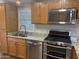 Updated kitchen features stainless steel appliances, granite countertops, and wood cabinets at 5933 E Main St # 1, Mesa, AZ 85206
