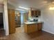 Open kitchen layout featuring an island, granite countertops, wooden cabinetry, and stainless appliances at 5933 E Main St # 1, Mesa, AZ 85206