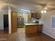 Open floor plan with a kitchen featuring stainless steel appliances, wood cabinets, and granite countertops at 5933 E Main St # 1, Mesa, AZ 85206