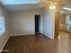 Open-concept living room with wood flooring and a view into the kitchen area at 5933 E Main St # 1, Mesa, AZ 85206