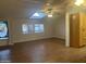 Bright living room with wood floors, ceiling fan, and ample natural light streaming through the window at 5933 E Main St # 1, Mesa, AZ 85206