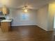 An empty living room features wood-like floors, a ceiling fan and updated kitchen at 5933 E Main St # 1, Mesa, AZ 85206