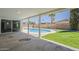 View from covered patio showing a beautiful backyard pool, grassy area, and block wall at 727 N Beverly --, Mesa, AZ 85201