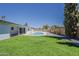 Beautiful backyard featuring a pool, lush green grass, and mature trees, creating a peaceful outdoor retreat at 727 N Beverly --, Mesa, AZ 85201