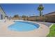 Outdoor pool and palm tree in a private backyard, creating a perfect oasis at 727 N Beverly --, Mesa, AZ 85201