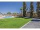 Expansive backyard with a stunning pool and lush lawn, ideal for outdoor entertaining and relaxation at 727 N Beverly --, Mesa, AZ 85201