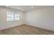 Bright bedroom with modern wood flooring and a large window with street views at 727 N Beverly --, Mesa, AZ 85201