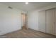 A bedroom with gray wood-look flooring and an attached closet at 727 N Beverly --, Mesa, AZ 85201