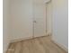 A well-lit bedroom with wood flooring, showcasing a white door and neutral wall color at 727 N Beverly --, Mesa, AZ 85201