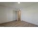 A bedroom with gray wood-look flooring and attached closet at 727 N Beverly --, Mesa, AZ 85201
