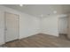 A well-lit bedroom showcasing a pristine white door and modern flooring, illuminated by recessed lighting at 727 N Beverly --, Mesa, AZ 85201