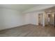 A spacious bedroom with gray wood-look flooring and an attached closet for storage at 727 N Beverly --, Mesa, AZ 85201