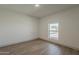 A bedroom with gray wood-look flooring and window to the outdoors at 727 N Beverly --, Mesa, AZ 85201