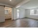 Bright bedroom with wood-look flooring and a sliding door leading to a bathroom and outdoor pool at 727 N Beverly --, Mesa, AZ 85201
