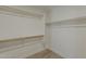A walk-in closet with wood rod shelving and gray wood-look flooring at 727 N Beverly --, Mesa, AZ 85201