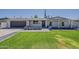 Charming single-story home with manicured lawn and stylish gray brick accents at 727 N Beverly --, Mesa, AZ 85201