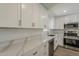 Stylish kitchen boasting stainless steel appliances, ample cabinet space, and elegant white countertops at 727 N Beverly --, Mesa, AZ 85201