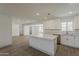 Open concept kitchen showcasing an island with stone countertop, stainless steel appliances, and bright, white cabinetry at 727 N Beverly --, Mesa, AZ 85201