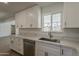 Kitchen featuring sleek stainless steel appliances, white cabinetry, and matching countertops near a bright window at 727 N Beverly --, Mesa, AZ 85201