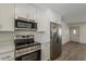 Kitchen featuring stainless steel appliances and a refrigerator, next to a door leading to other rooms at 727 N Beverly --, Mesa, AZ 85201