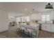 Modern, open kitchen with sleek white cabinets, stainless steel appliances, and a spacious island with breakfast bar seating at 727 N Beverly --, Mesa, AZ 85201