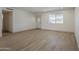 Spacious living room filled with natural light, showcasing a window, entry door, and modern flooring at 727 N Beverly --, Mesa, AZ 85201